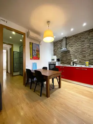 a kitchen and dining room with a wooden table and chairs at Stay U-nique Apartments Sagrada Familia III in Barcelona