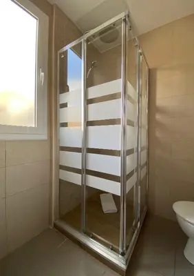 a glass shower in a bathroom with a toilet at Stay U-nique Apartments Sagrada Familia III in Barcelona