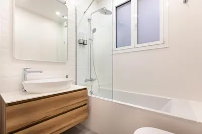 a white bathroom with a sink and a shower at Majestic 4BR/4BATH apartment in Sagrada Familia area in Barcelona