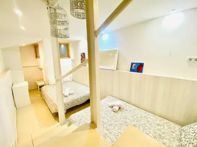 a room with two beds and a sink in it at 06 DUPlEX LOFT in Barcelona