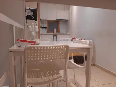 a kitchen with a white table and chairs at 06 DUPlEX LOFT in Barcelona