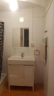 a white bathroom with a sink and a mirror at 06 DUPlEX LOFT in Barcelona