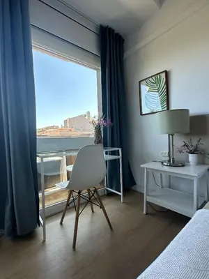 a bedroom with a bed and a desk and a window at Plaza Spain Barcelona Apartments in Barcelona