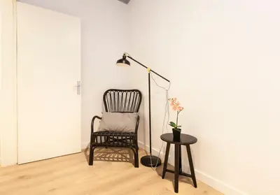 a black chair and a table with a lamp at 1521 - AB Sagrada Família Comfort in Barcelona