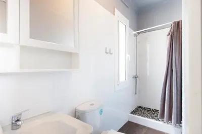a white bathroom with a toilet and a window at 1521 - AB Sagrada Família Comfort in Barcelona