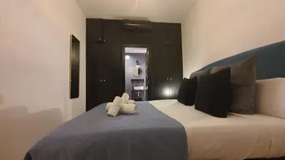 a stuffed animal is sitting on a bed at Barrio Gotico Apartments Escudellers in Barcelona