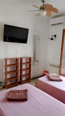 a bedroom with two beds with pink sheets at Habitaciones Yanet in La Granada