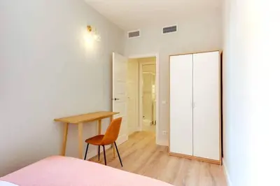 a bedroom with a desk and a chair and a mirror at Bright 2bdr In Trendy Gracia in Barcelona