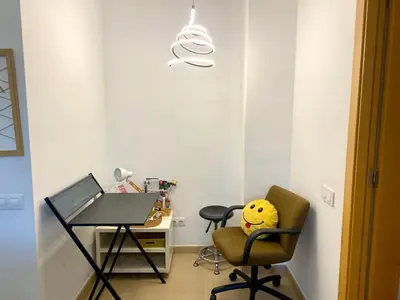 a room with a desk and a chair and a table at Terraza Relajante Galvani in Terrassa