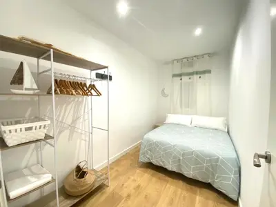 a bedroom with a bed and a glass closet at Lovely New apartment 20 minutes from Barcelona center. in Barcelona