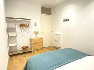a white room with a bed and a closet at Lovely New apartment 20 minutes from Barcelona center. in Barcelona