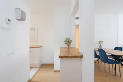 a kitchen and dining room with a table and chairs at Livefull 2bdr In Trendy Gracia in Barcelona