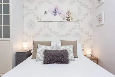 a bedroom with a white bed with a pillow on it at Central 2 Bedroom By Sagrada Familia in Barcelona