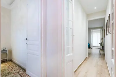 a hallway with white walls and a door at Lovely Designed House Connected To Center in Cornellà de Llobregat