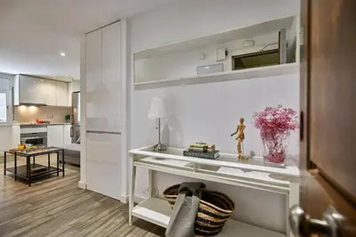 a living room with a table with a vase of flowers at BBarcelona Sant Pau Flat in Barcelona
