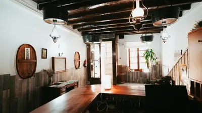 a large room with a wooden table in it at Hostal La Premsa in Arenys de Mar