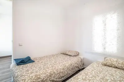a bedroom with two beds with a hat on top at LOVELY APARTMENT Barca 2 in Sant Adria de Besos