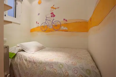 a bedroom with a bed with a bike on the wall at rentBCN Gracia Jardinets in Barcelona