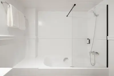 a white bathroom with a shower and a sink at H Regas Adults Only in Barcelona
