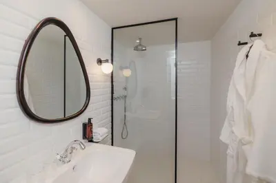 a white bathroom with a sink and a mirror at H Regas Adults Only in Barcelona