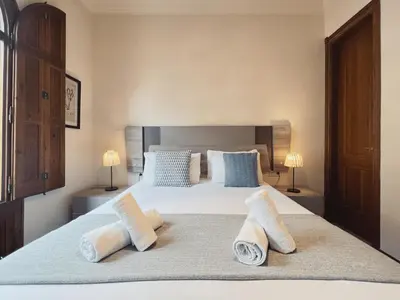 a bedroom with a large bed with two pillows at Stay U-nique Apartments Industria II in Barcelona