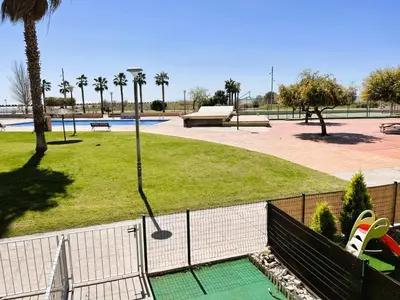 a view of a park with a park with a playground at Onze - primera línea de mar con piscina in Cubelles
