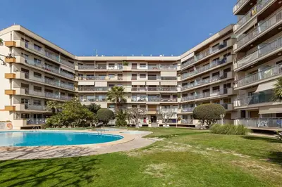 an apartment building with a swimming pool and a yard at Apartment Muralla in Vilassar de Mar