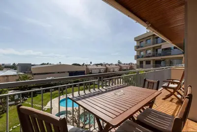 a balcony with a wooden table and chairs at Apartment Muralla in Vilassar de Mar