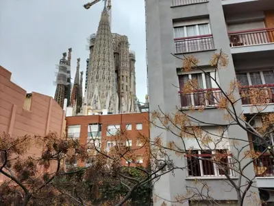 a view of a cathedral from between buildings at Montserrat Apartments by gaiarooms in Barcelona