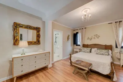 a bedroom with a bed and a mirror on the wall at Edard's Great House in Castelldefels
