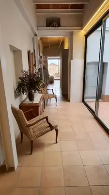 a living room with chairs and a table on a tile floor at Opening Doors Vilassar. Family house Beach & Relax in Vilassar de Mar