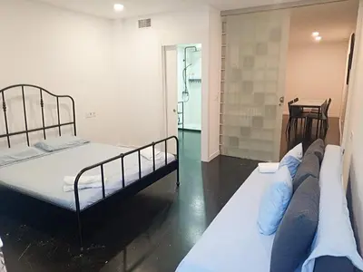 a bedroom with two beds and a mirror at HUG HOTEL2022 in El Carrer del Canonge