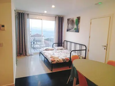 a bedroom with a bed and a table and a balcony at HUG HOTEL2022 in El Carrer del Canonge