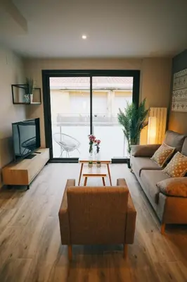 a living room with a couch and a table at RCE Apartments Calella, brand new next to the beach. in Calella