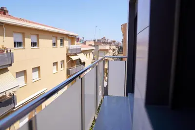 a balcony with a view of a building at RCE Apartments Calella, brand new next to the beach. in Calella