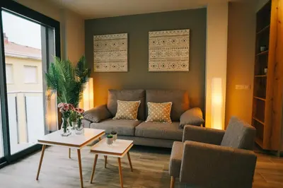 a living room with a couch and two tables at RCE Apartments Calella, brand new next to the beach. in Calella
