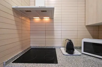 a kitchen with a counter with a microwave and a sink at The White Flats Sant Antoni in Barcelona