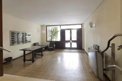 a hallway with a table and chairs in a building at Key Gracia Apartments in Barcelona