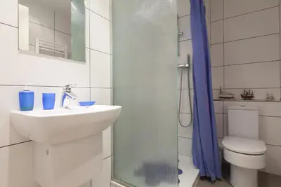 a bathroom with a sink and a shower and a toilet at Key Gracia Apartments in Barcelona