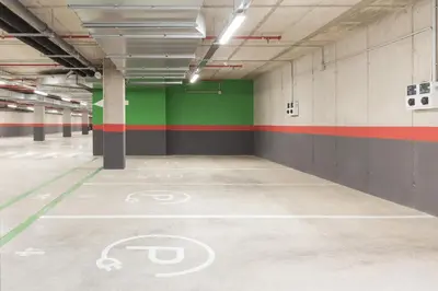 an empty parking garage with a bike painted on the floor at Holiday Inn Barcelona - Sant Cugat by IHG in Sant Cugat del Vallès
