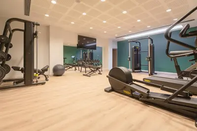 a gym with several treadmills and machines in a room at Holiday Inn Barcelona - Sant Cugat by IHG in Sant Cugat del Vallès