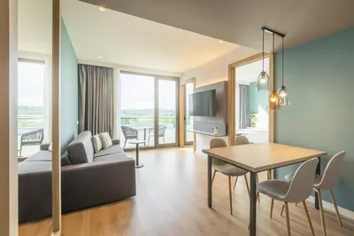 a living room with a couch and a table at Holiday Inn Barcelona - Sant Cugat by IHG in Sant Cugat del Vallès