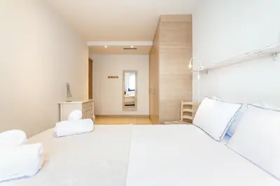 a bedroom with a large white bed with white pillows at Casa 20 minutos de Barcelona y WIFI alta capacidad in Sant Cugat del Vallès