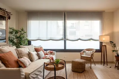 a living room with a couch and two large windows at Casa 20 minutos de Barcelona y WIFI alta capacidad in Sant Cugat del Vallès