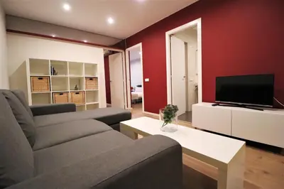 a living room with a couch and a tv at Weflating Sant Antoni Market in Barcelona