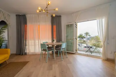 a dining room with a table and chairs and a window at HomeHolidaysRentals Eiffel - Costa Barcelona in Pineda de Mar