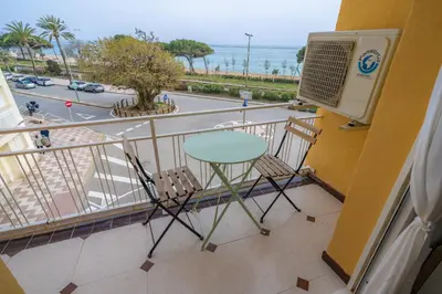 a balcony with a table and chairs and a view of a street at HomeHolidaysRentals Eiffel - Costa Barcelona in Pineda de Mar