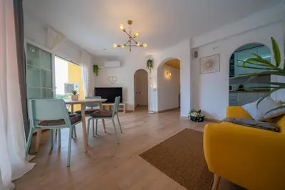 a dining room and living room with a table and chairs at HomeHolidaysRentals Eiffel - Costa Barcelona in Pineda de Mar