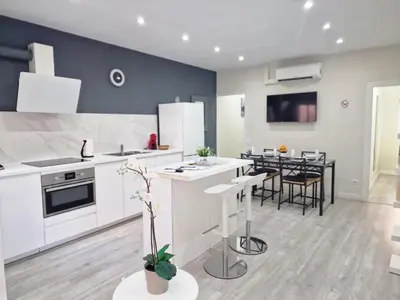 a kitchen with white appliances and a dining room at Barcelona 2 Habitaciones in Hospitalet de Llobregat