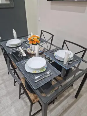 a black table with plates and utensils on it at Barcelona 2 Habitaciones in Hospitalet de Llobregat
